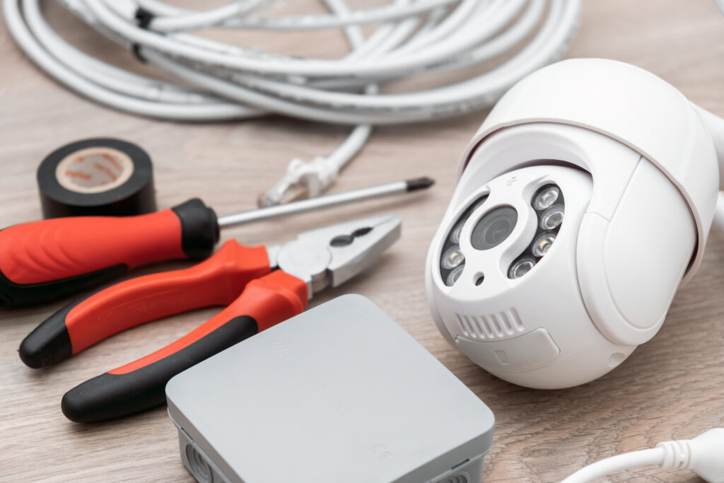 cable, screwdriver and pliers for installation of intelligent ip cctv camera on the table