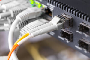 close up of high speed fiber network switch and cables in datacenter